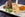 Haggis and turnip and potato mash and sweet potato mash presented in a plate with a cooked half haggis and a lamb's leaf lettuce, traditional food of Scotland presented in a modern way (Photo by