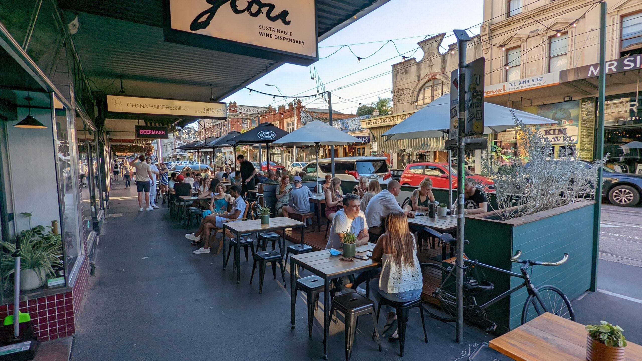 People dining at outdoor tables.