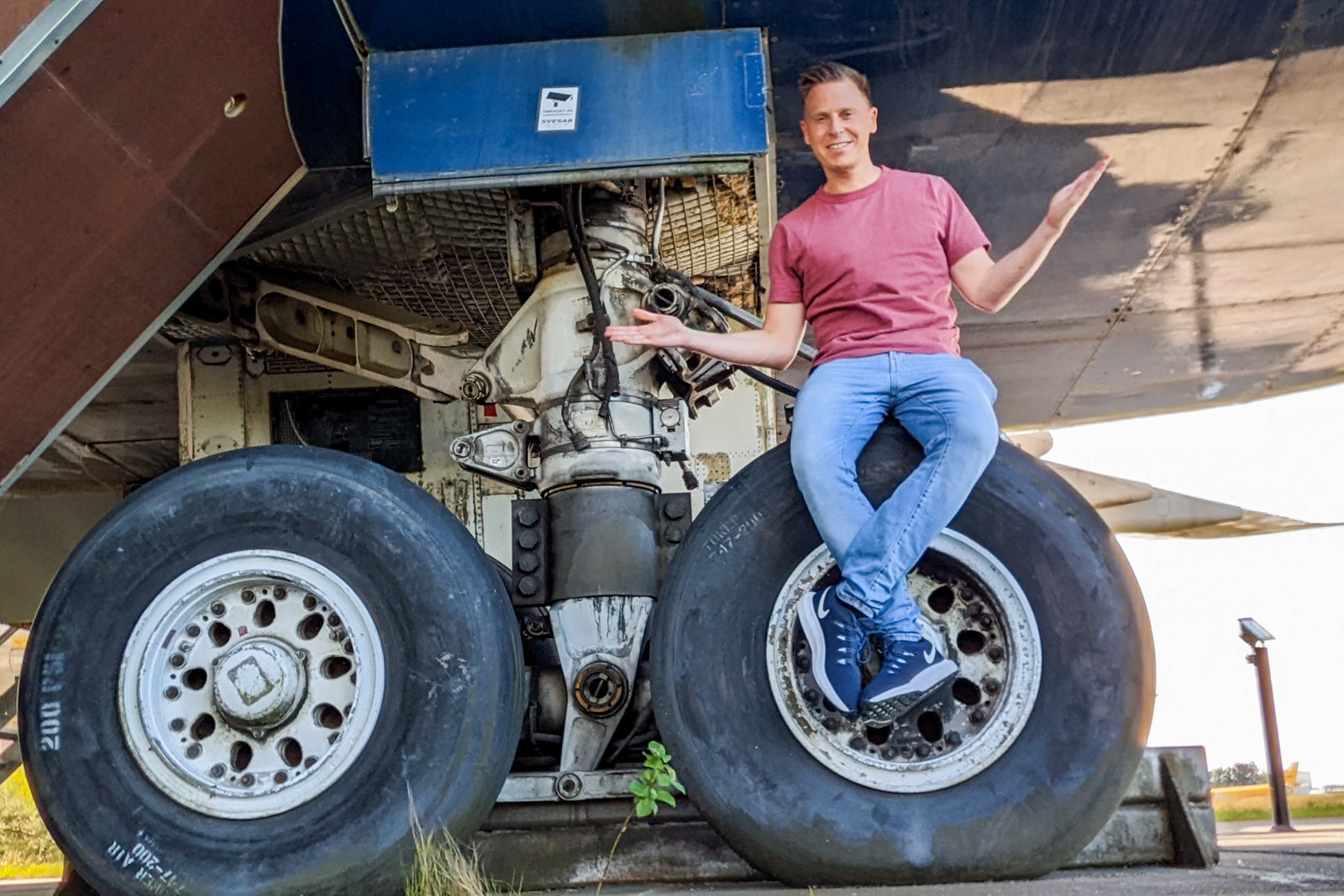 sitting on tire of airplane