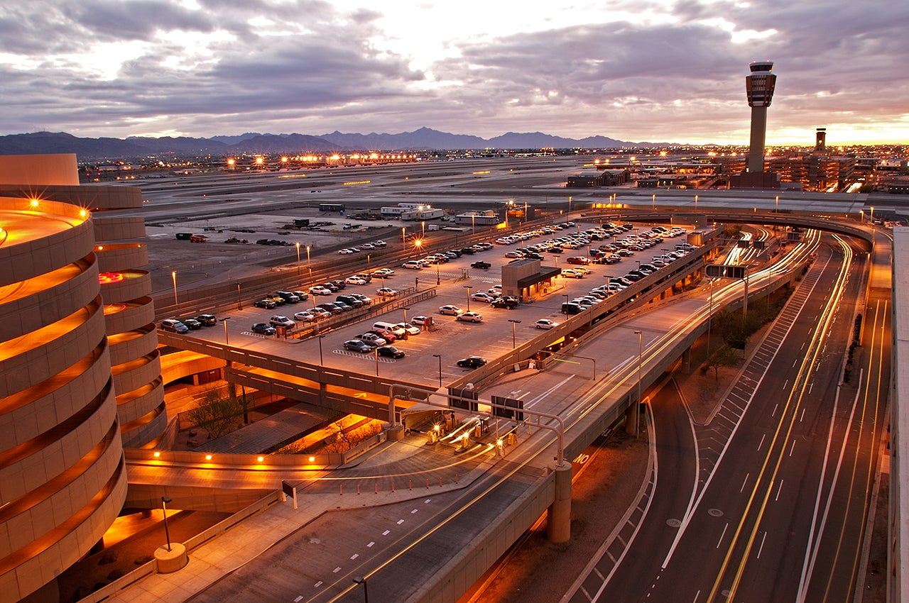 An airport parking lot at sunset