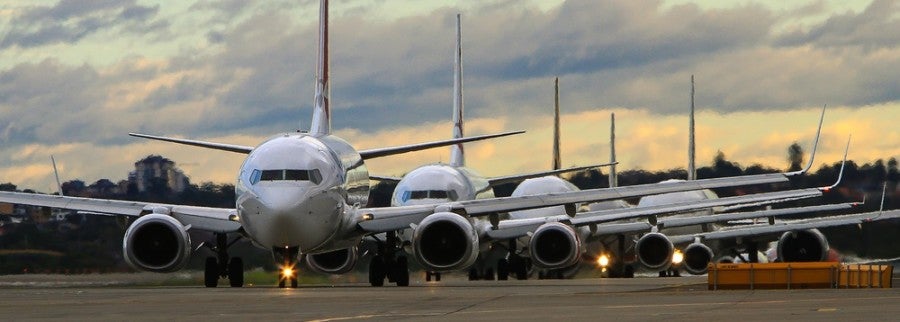 Airplanes in line on runway shutterstock 198700100