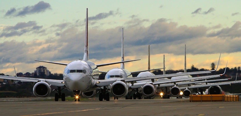 airplanes in line on runway full shutterstock 198700100