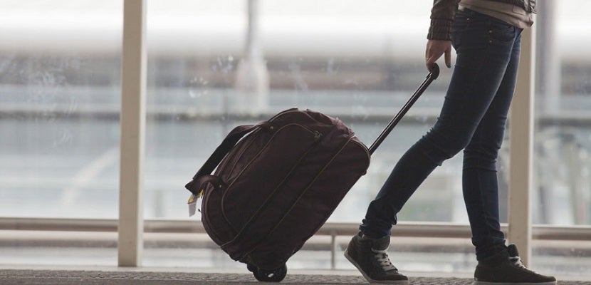 Luggage bag roller in airport featured shutterstock 1919895081