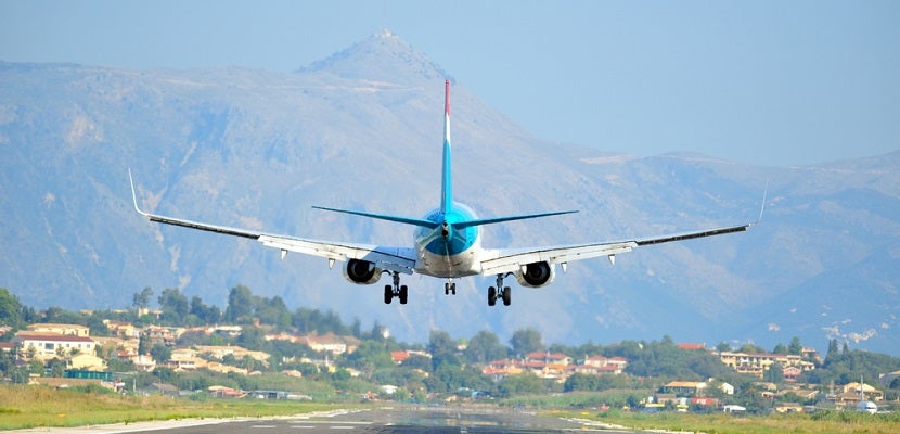 Plane landing Corfu mountains featured shutterstock 56429125