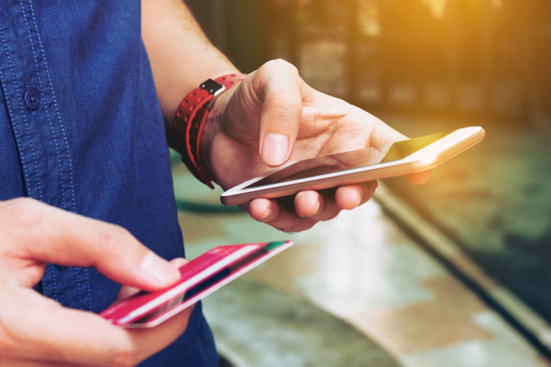 Man use smart phone and holding credit card with shopping