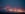 Colorful fogbound landing lights guide airplanes to runway.