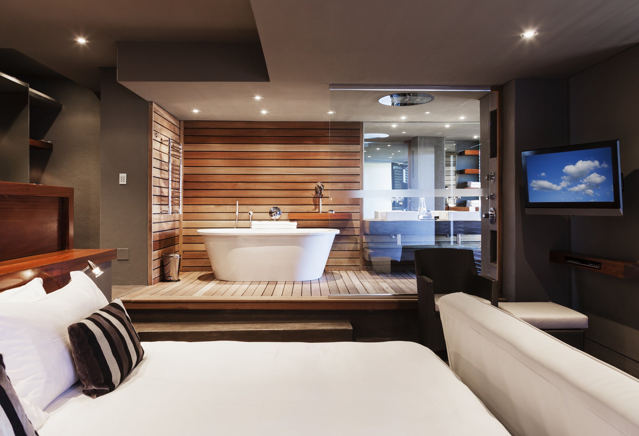 Bed and bathtub in modern master bedroom