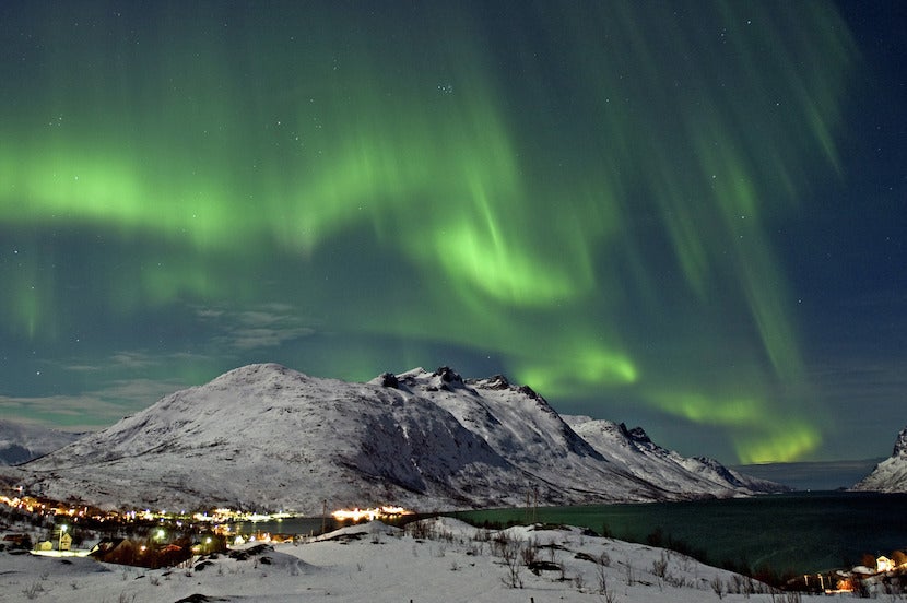 Make your way to the Arctic Wilderness for an almost guaranteed sighting of the Northern Lights over Ersfjord in Tromsø. Image courtesy of Bjørn Jørgensen/VisitNorway.com.
