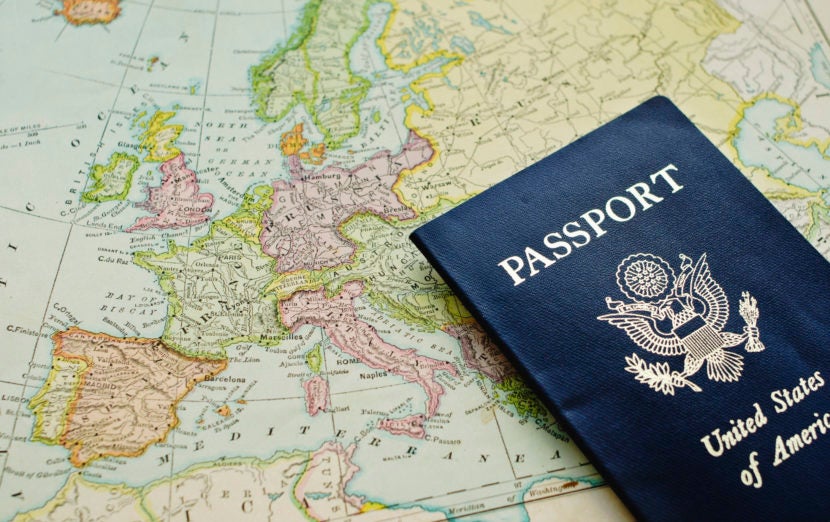 Close-up of passport lying on European map