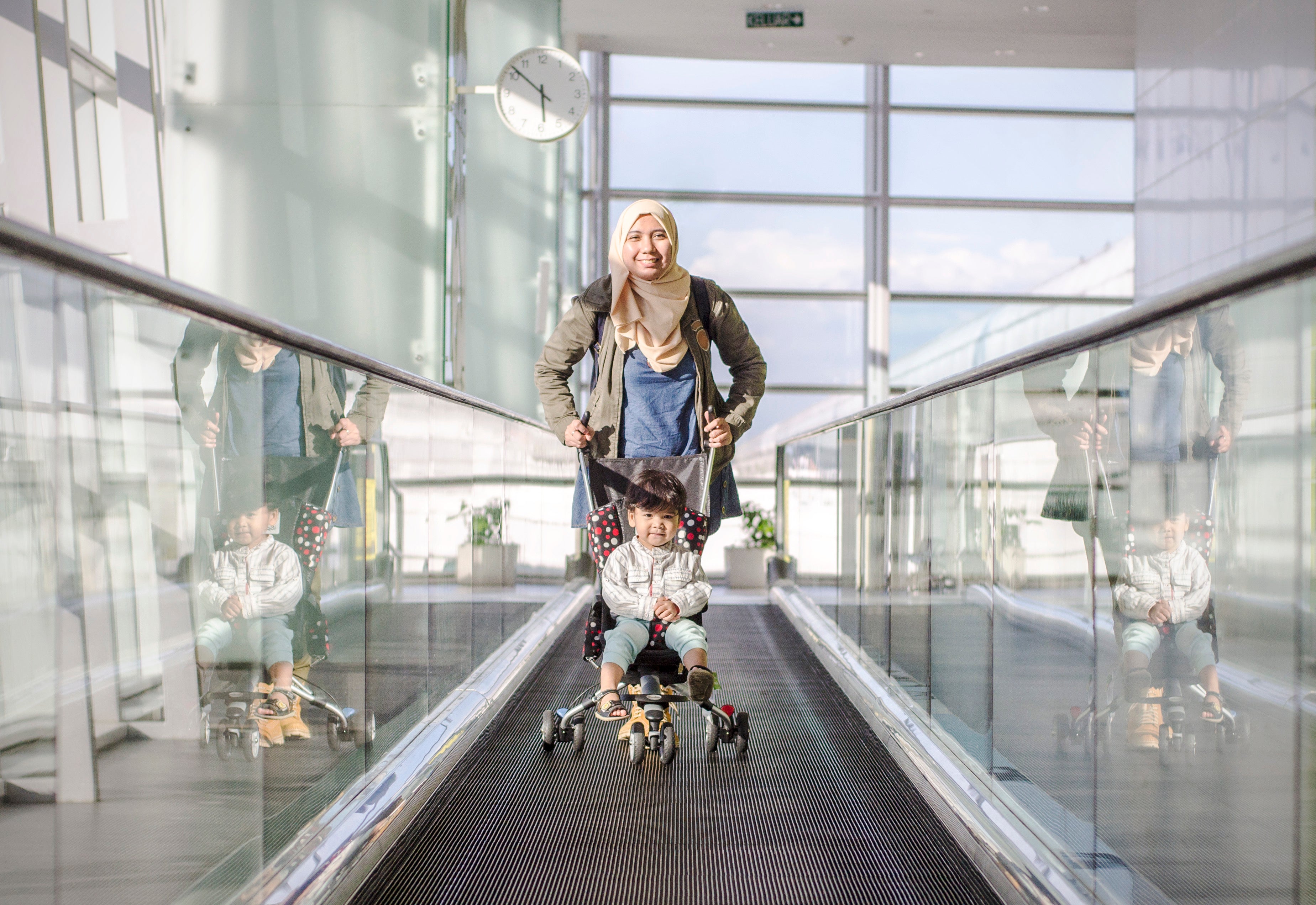 Traveling child mother family airport stroller