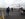 Passengers walk to the aircraft, past several others nearby.