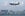 A Cathay Pacific plane flies over the city. Image by Dale de la Rey/Getty Images.