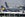 An aircraft operated by Singapore Airlines Ltd. passes the tailfins of Deutsche Lufthansa AG airplanes during a strike at Frankfurt airport in Frankfurt, Germany, on Tuesday, March 27, 2012. Deutsche Lufthansa AG, Europe's second-biggest airline, said it still estimates that 400 flights worldwide will be cancelled today because of a strike by baggage handlers in Germany. Photographer: Hannelore Foerster/Bloomberg via Getty Images