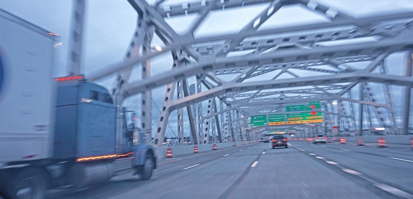 Semi truck crossing bridge over Ohio river