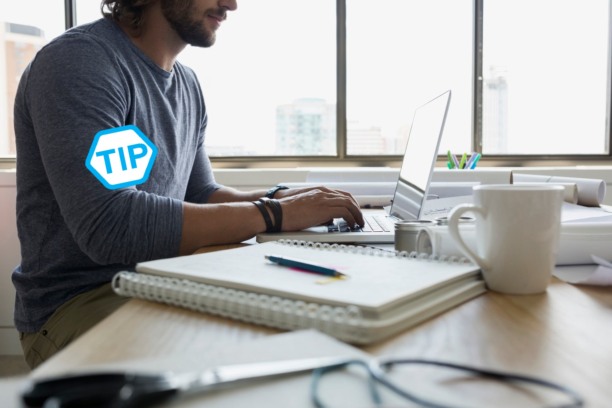 Architect using laptop at desk in office