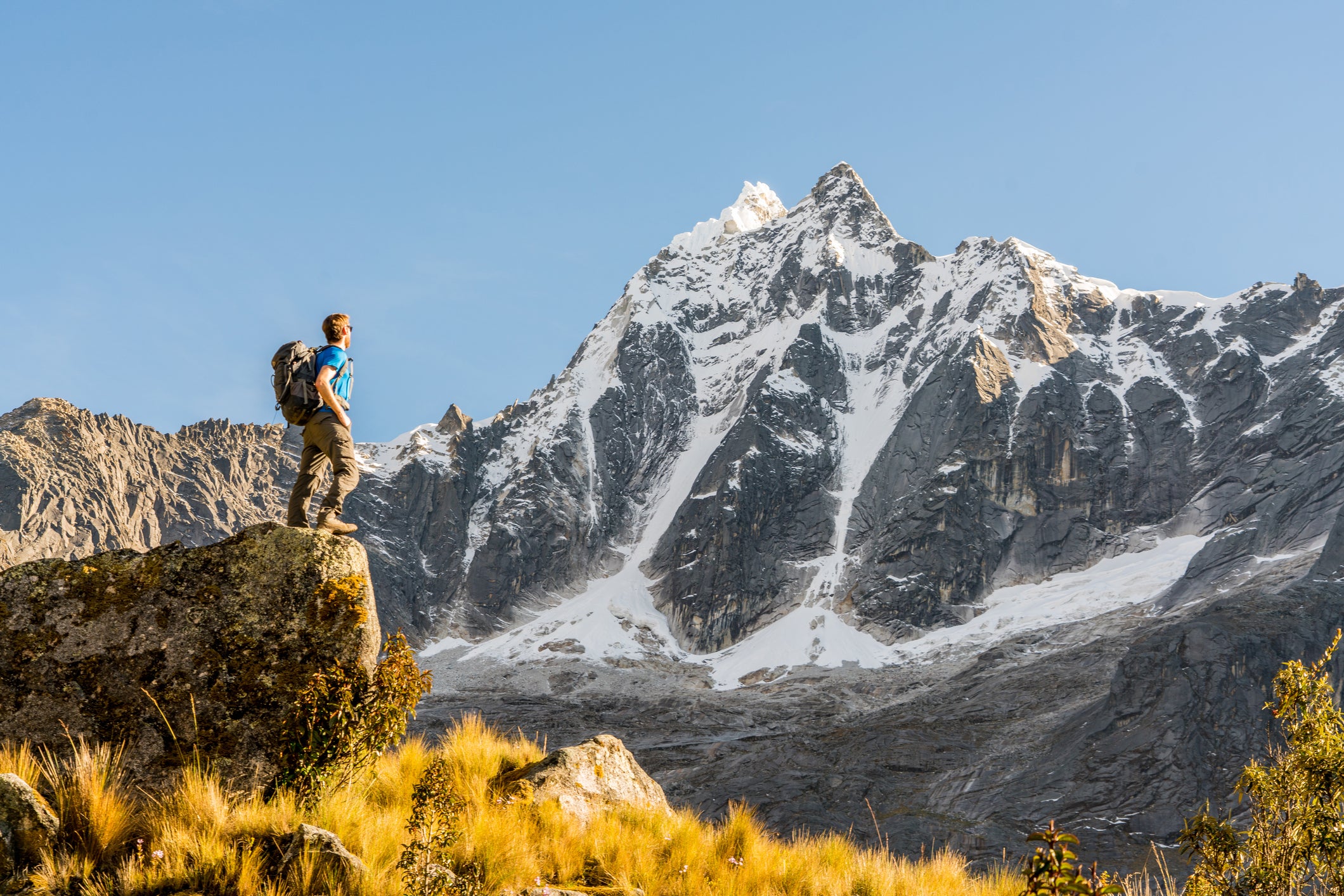 Low Angle View Of Person Standing On Rock Against Sky