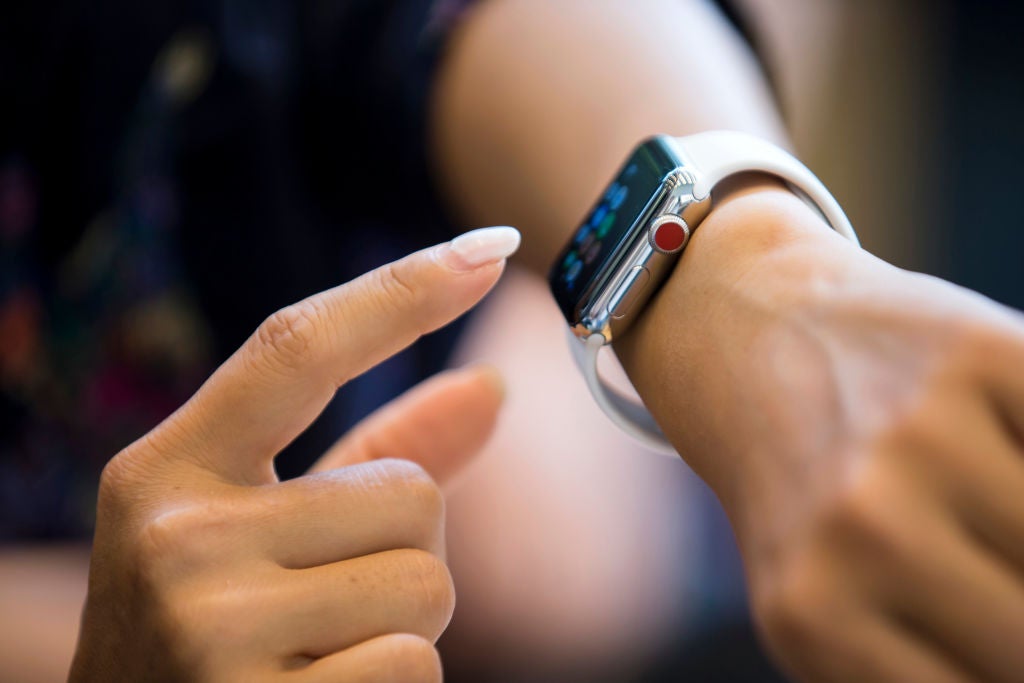 a smartwatch on an unseen person's wrist