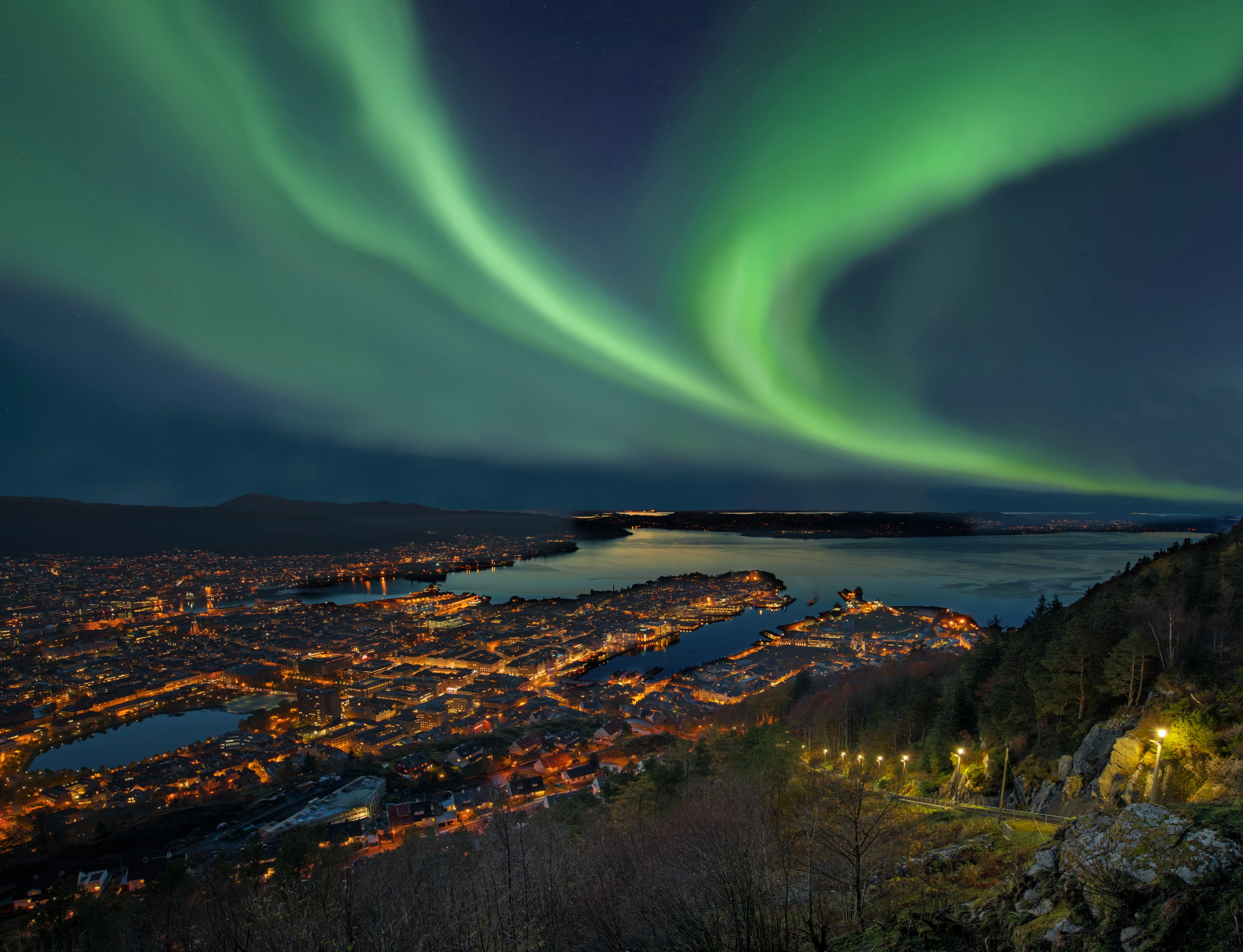 The Northern Lights over harbor of Bergen City, Norway. Image by RelaxFoto.de / Getty Image.
