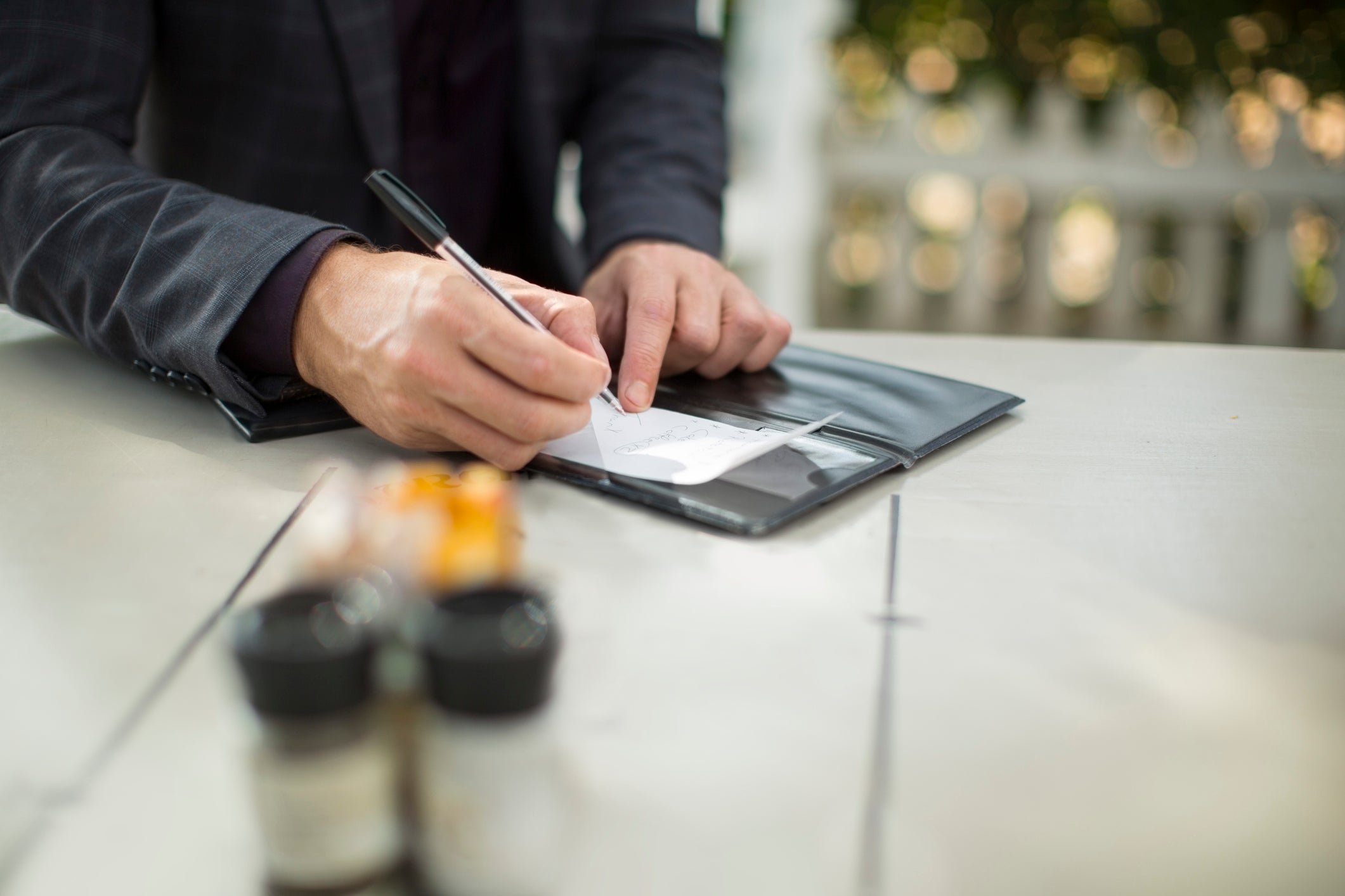 Businessman signing the bill at restaurant