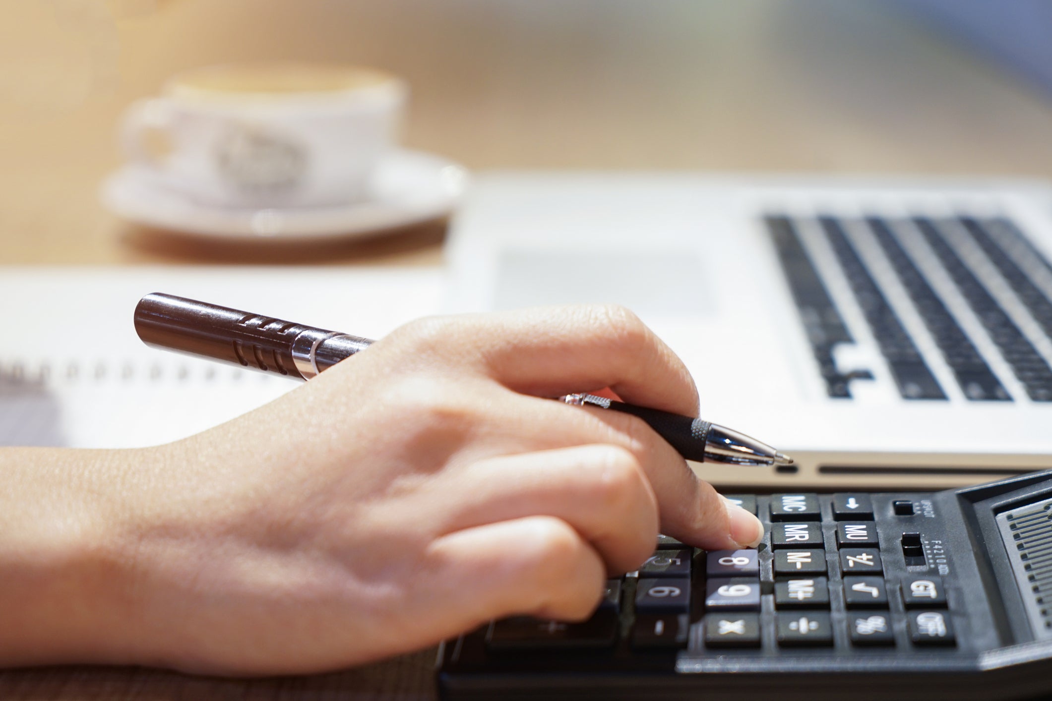 Person typing numbers into a calculator