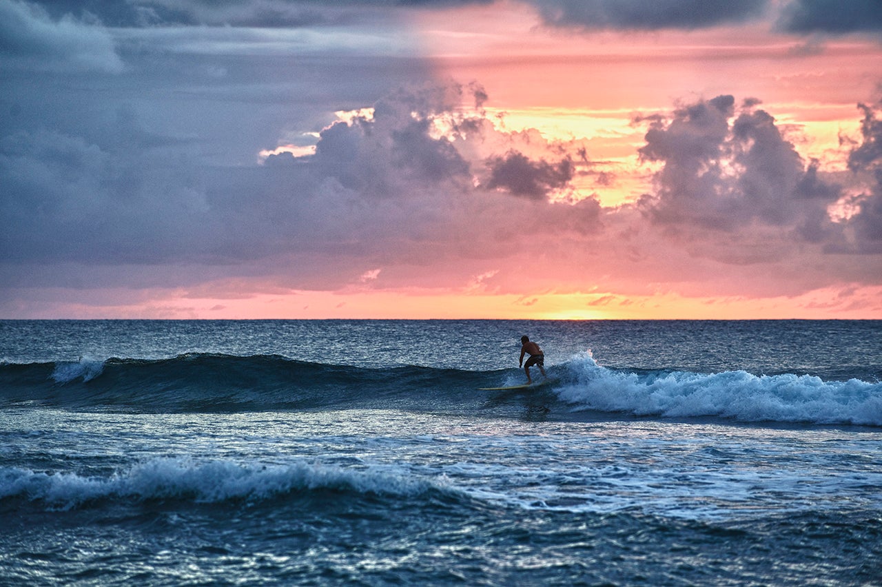 Surfer at sunset in Rincon