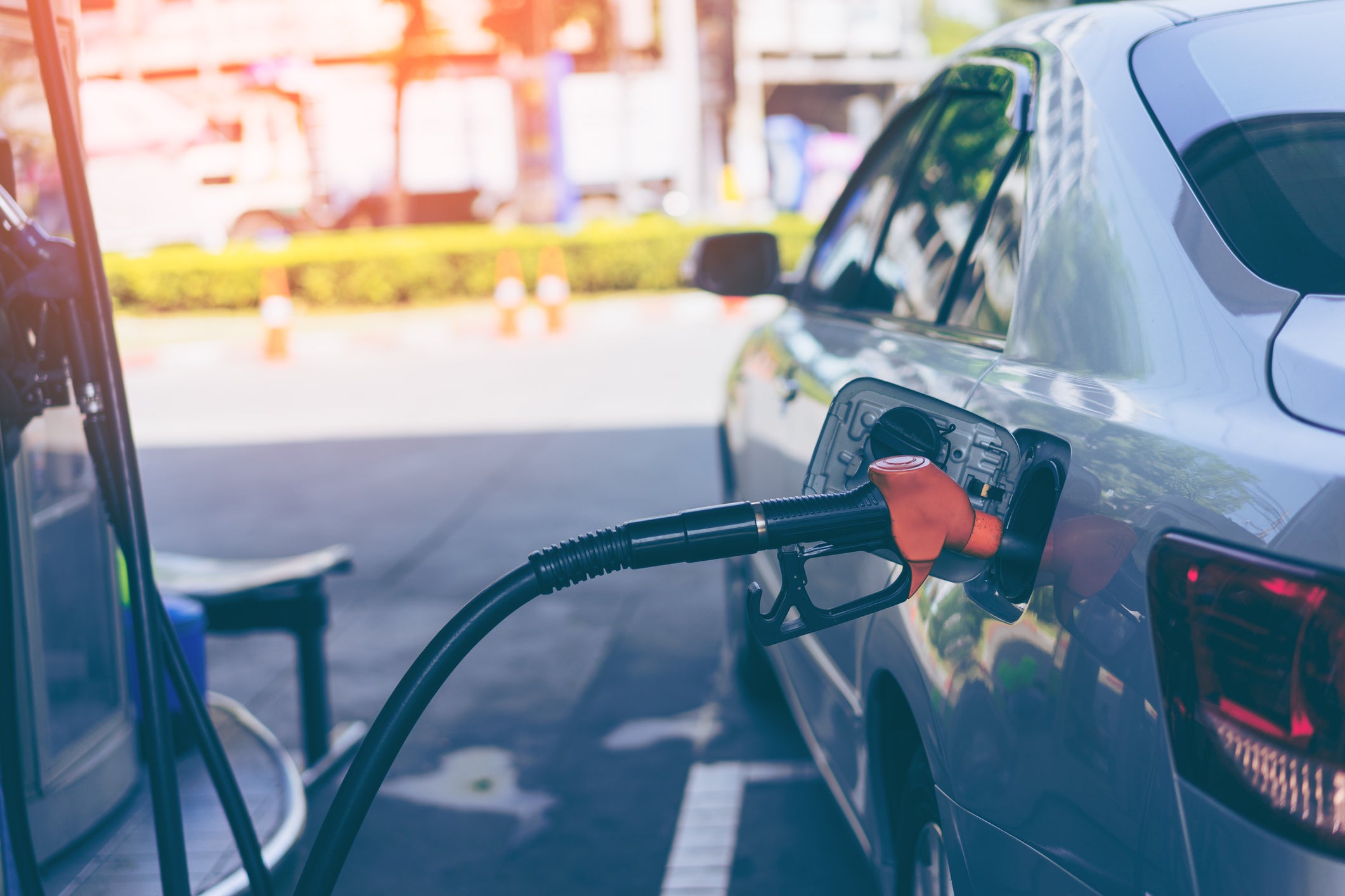 Pumping gasoline fuel in car at gas station