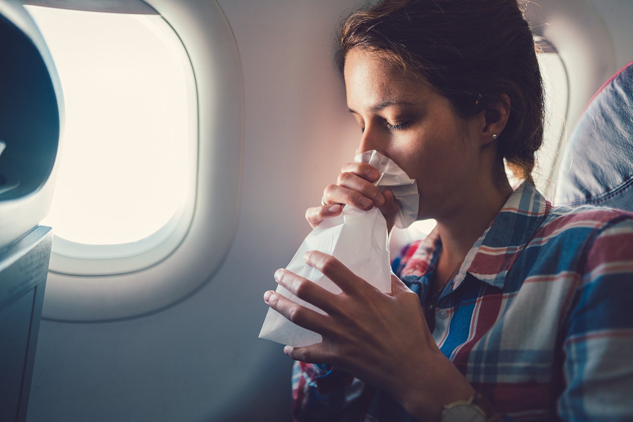 Sick woman with nausea in the airplane