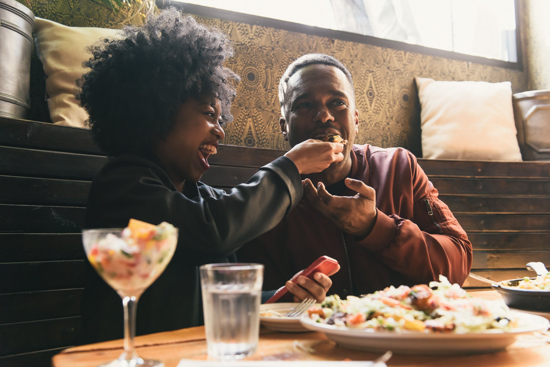 A black couple shares a meal together