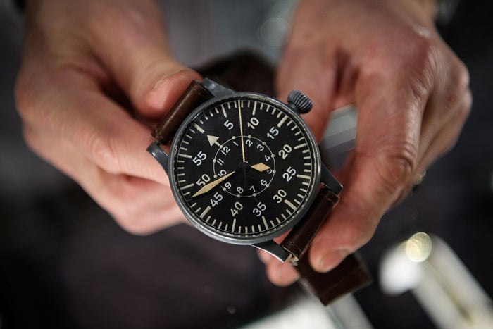 LONDON, ENGLAND - JANUARY 05: A man holds a Wempe aviator watch from 1943 (£5200) at the Mayfair Antiques and Fine Art Fair on January 5, 2017 in London, England. Running from January 5 to Sunday 8, the fair sees over forty exhibitors with pieces ranging from 1300BC to the present day available for sale. (Photo by Leon Neal/Getty Images)