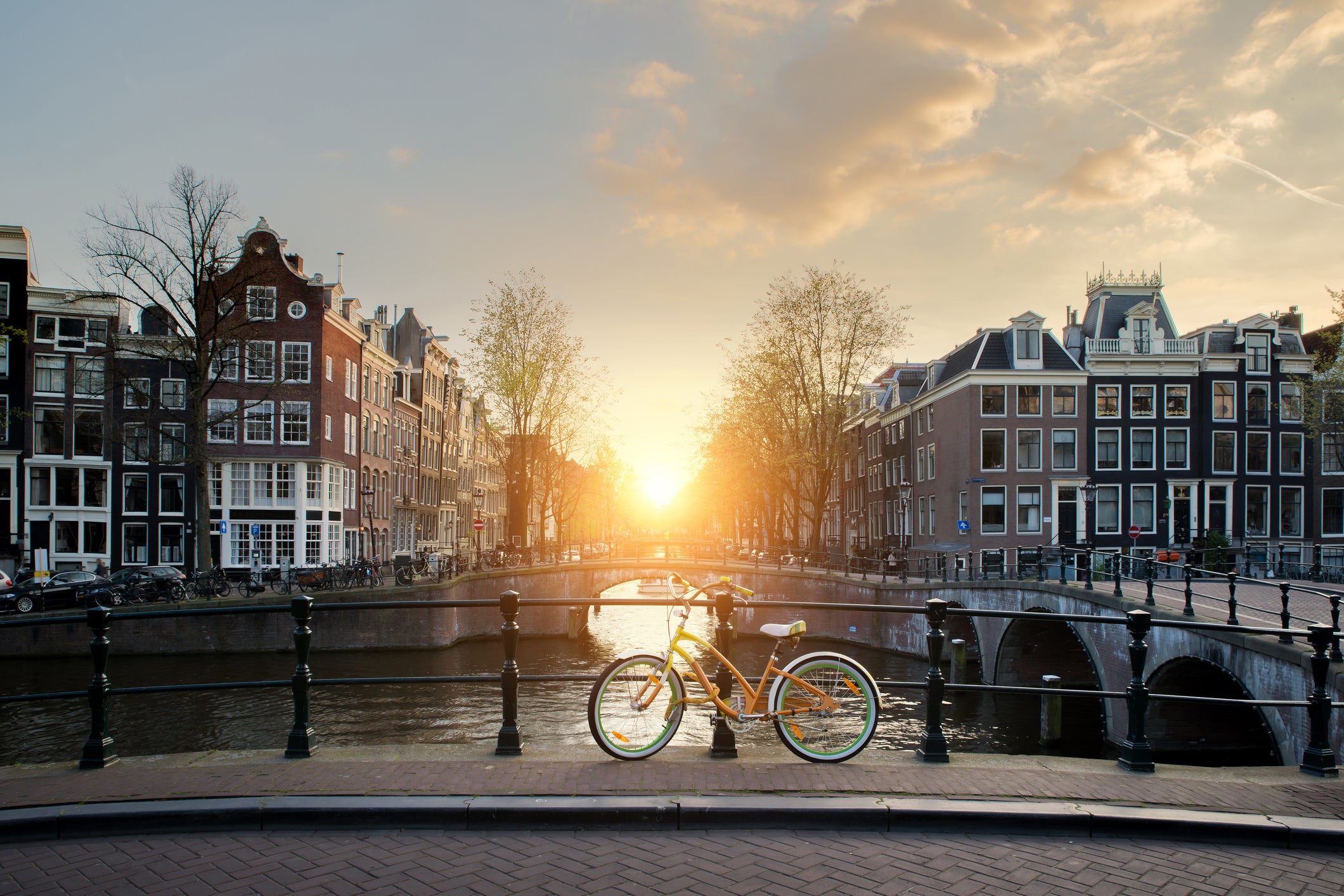 Bicycles lining a bridge over the canals of Amsterdam, Netherlands. Bicycle is major form of transportation in Amsterdam, Netherlands.