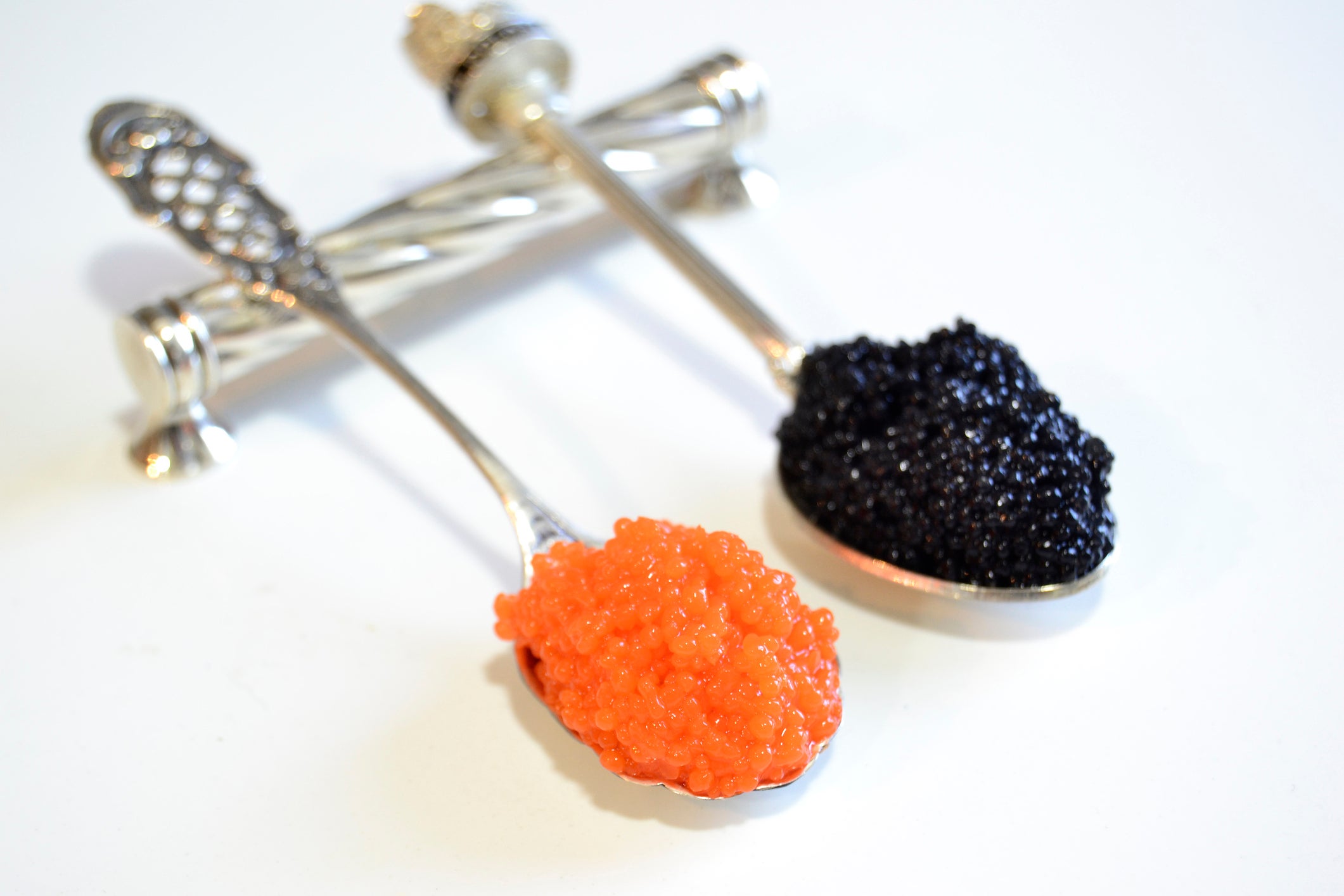 Red and black caviar on silver teaspoon