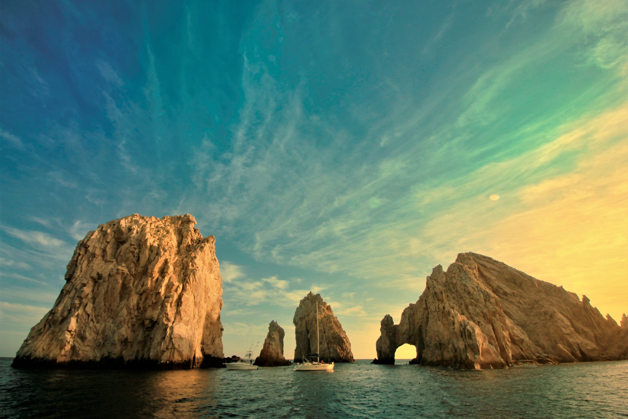 Rock Formations In Sea Against Sky