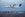 A Porter Airlines Q400 Turboprop; Toronto skyline in view. (Image via Porter Airlines)