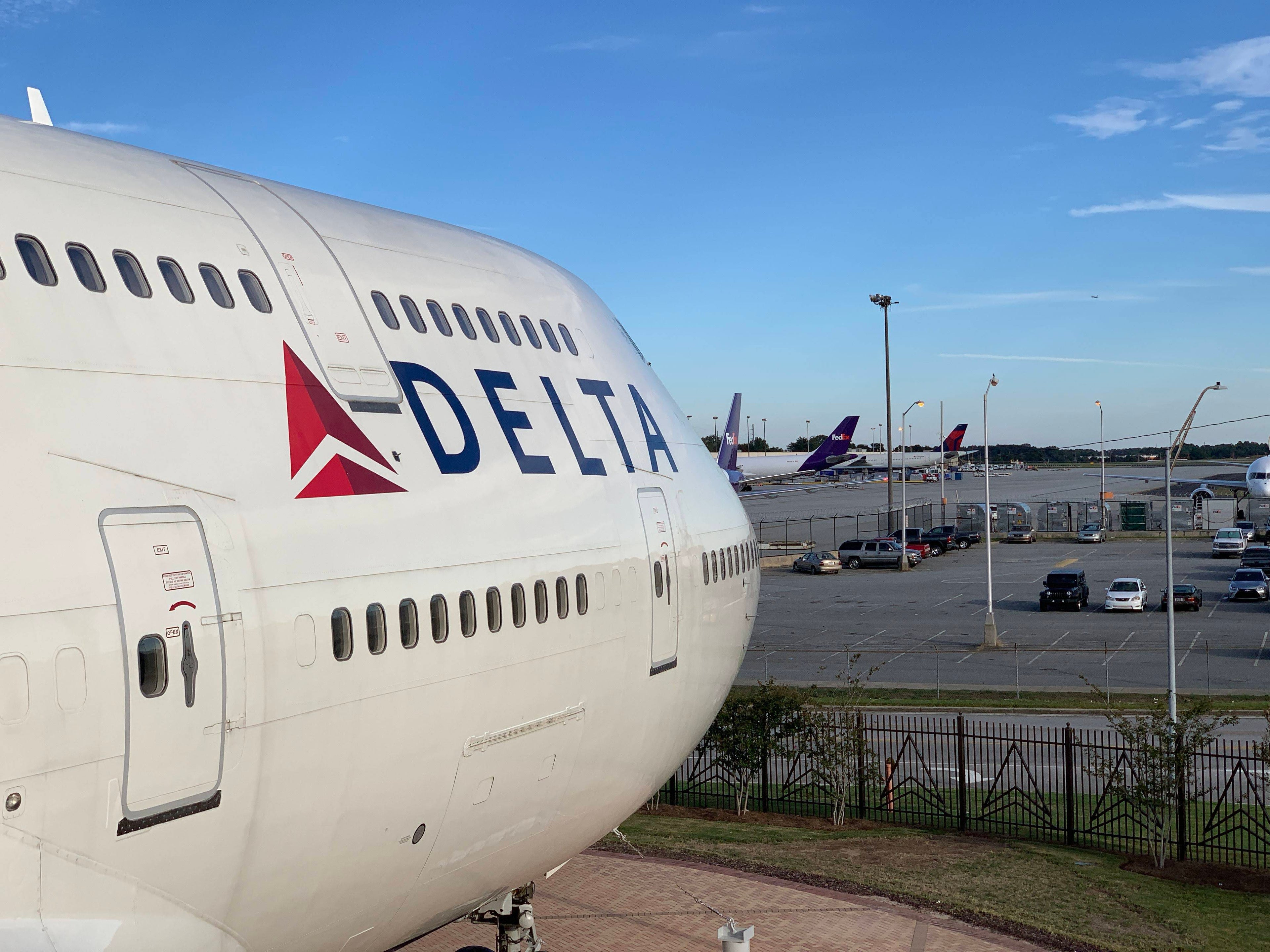 Delta Flight Musem - Boeing 747-400 peering over ATL Airport