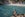 On 24 August 2018, a man with a selfie stick takes photos of a woman floating in the water at Buyukcakil beach a natural cove along the Mediterranean coast near the village of Kas in Antalya, Turkey, also known as the Turkish Riviera, which has an economy heavily dependent on the tourism industry, foreign visitors. (Photo by Diego Cupolo/NurPhoto via Getty Images)