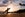 Surfer at silhouette in sunset on tropical beach in Maui, Hawaii.
