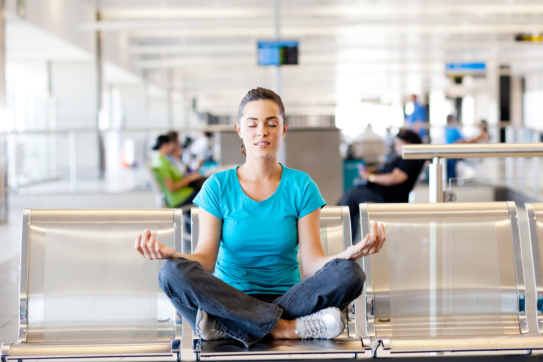 Woman meditates at airport