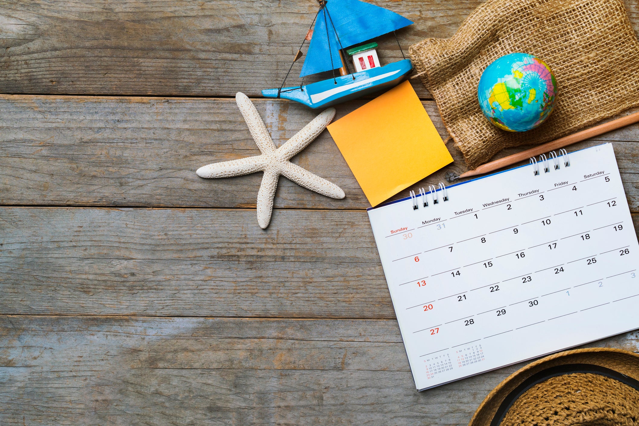 concept of travel vacation trip and long weekend planning  with calendar on wooden background