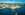 Panoramic aerial view over the blue summer skies above the iconic waterfront of Gamla Stan and Sodermalm in the heart of Stockholm, Sweden's vibrant capital city.