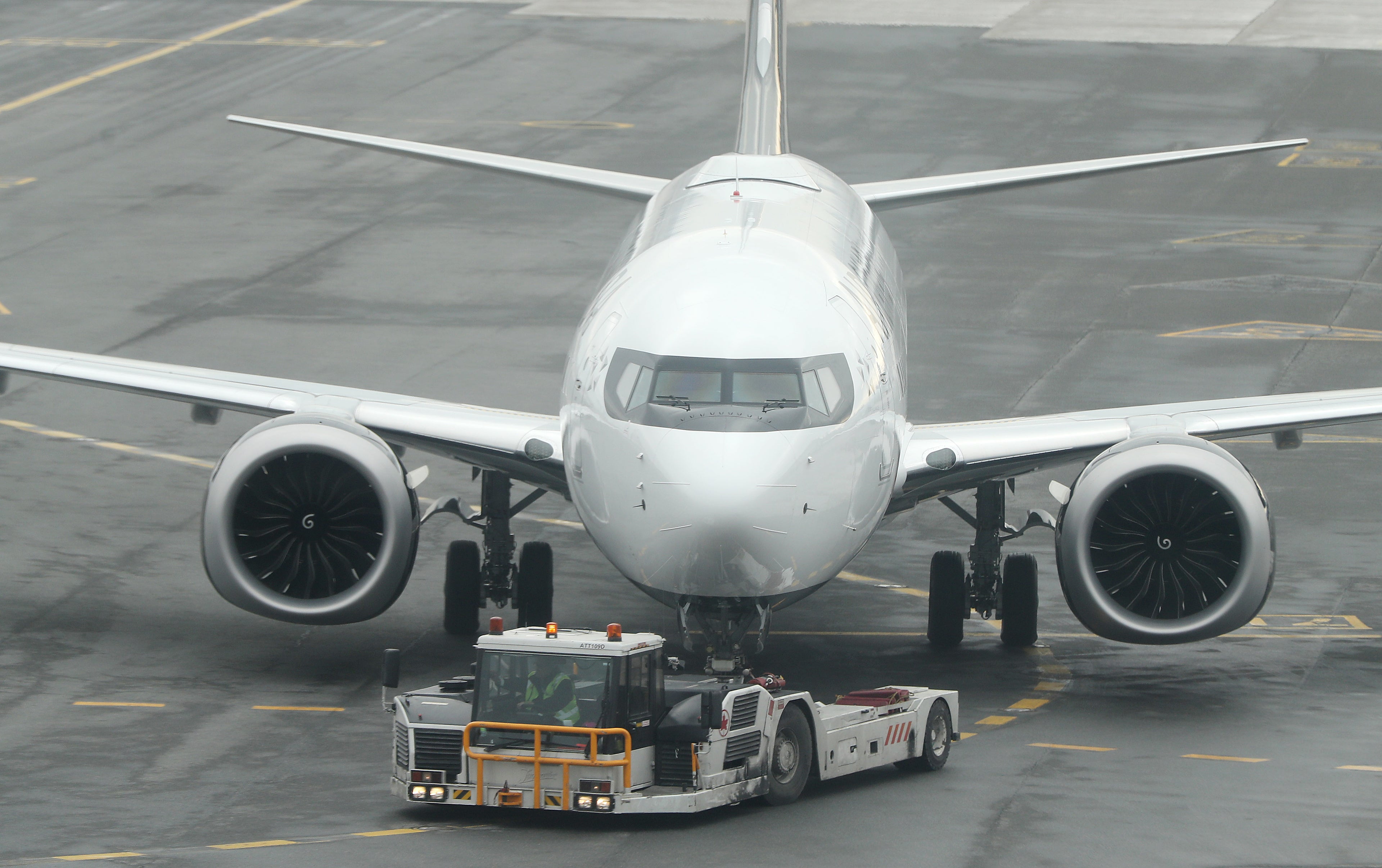 Air Canada Registration number C-GEHV which had just come in as Flight AC 758, from San Francisco, a 737 Max 8, is rolled out of the gate after being grounded,