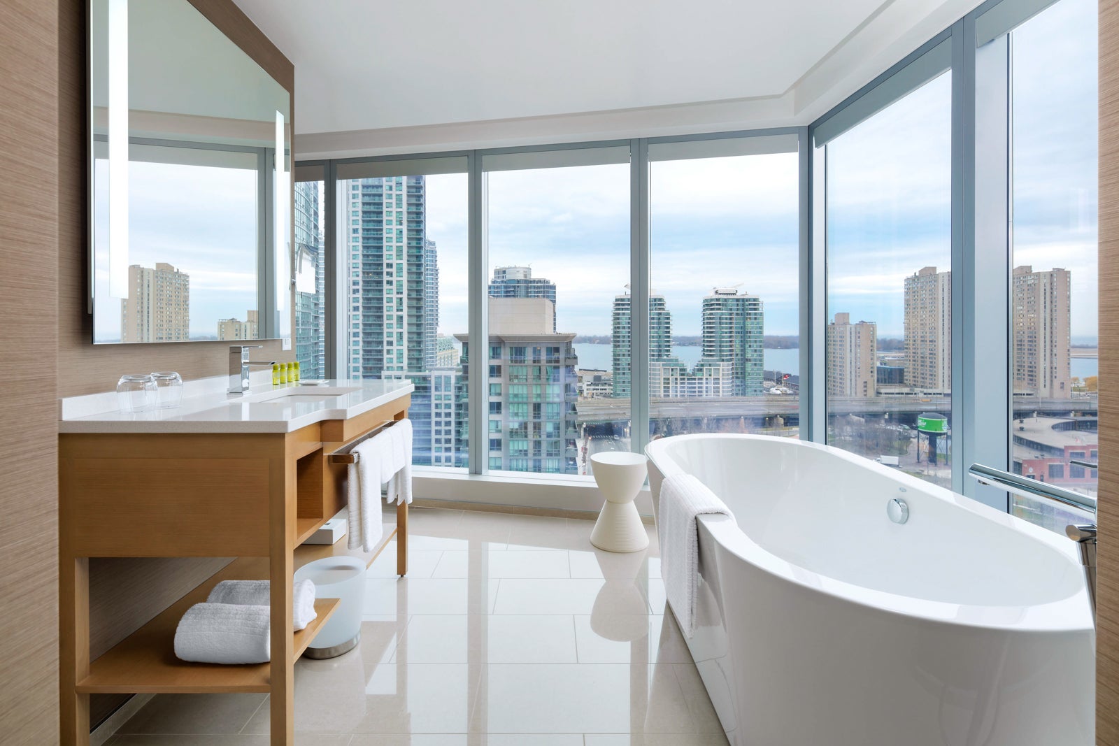 large bathtub in room with floor-to-ceiling windows