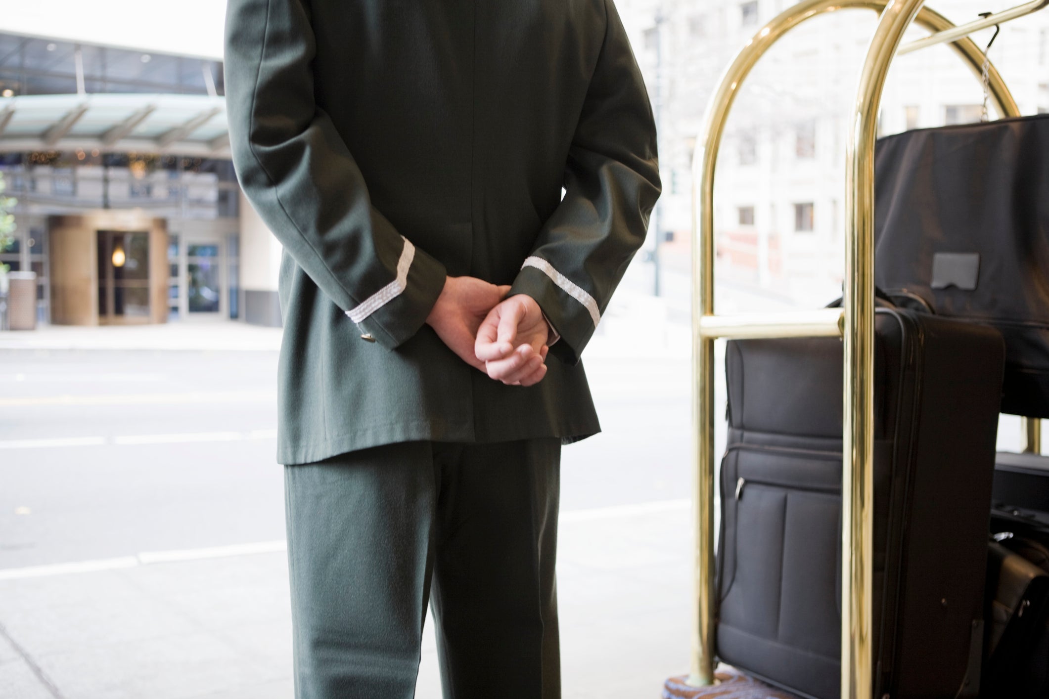 Bellhop with hands behind  back