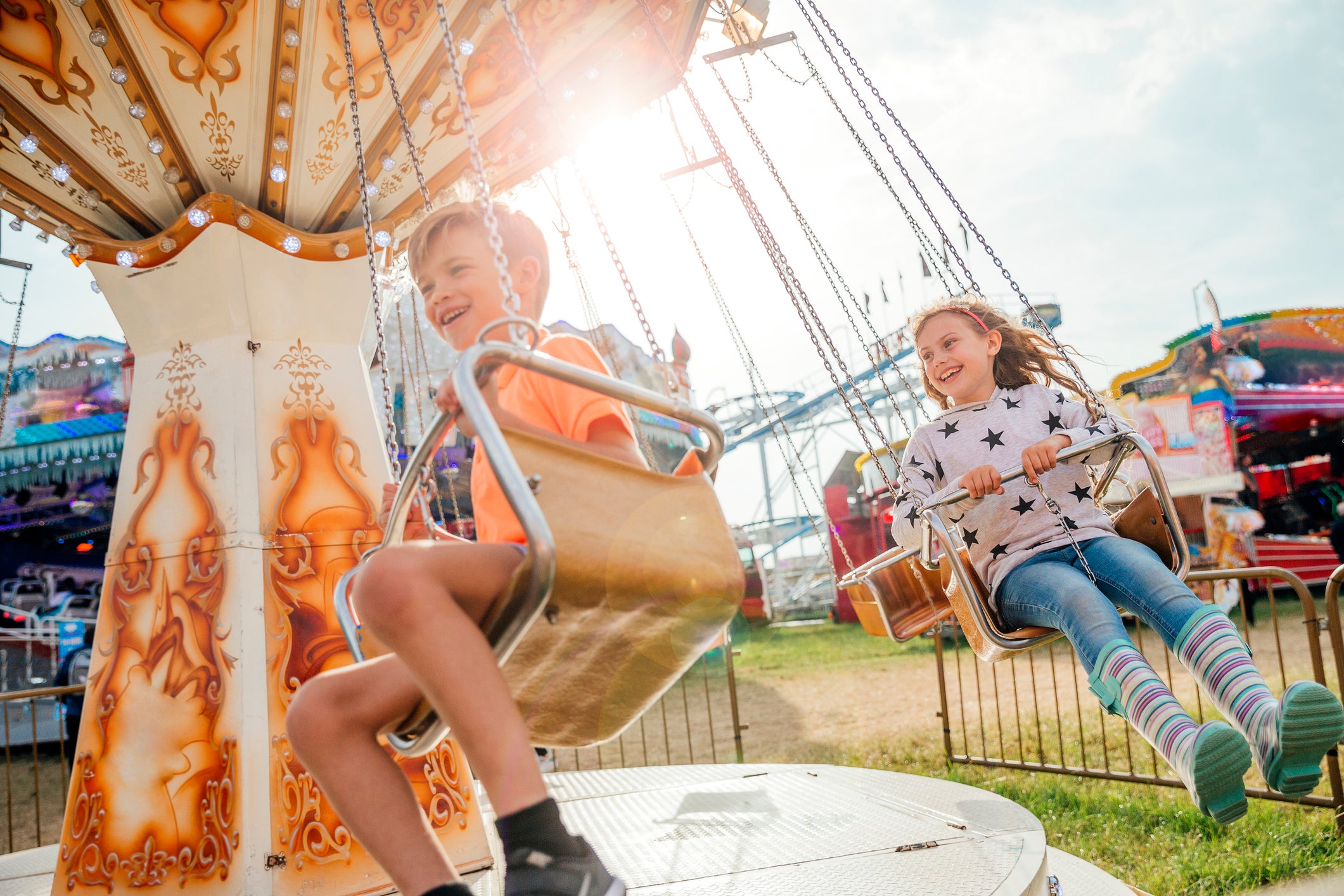 Children Riding on the Swings at the Fairground