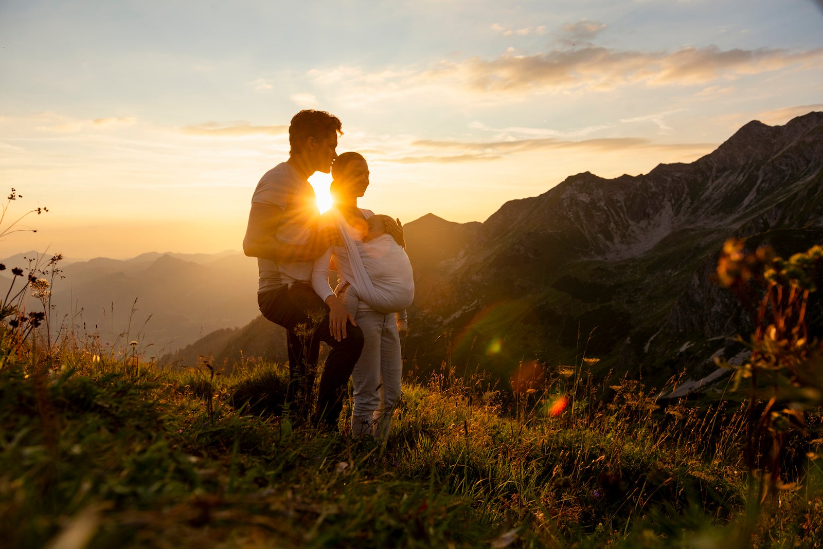 Germany, Bavaria, Oberstdorf, family with little daughter on a hike in the mountains at sunset