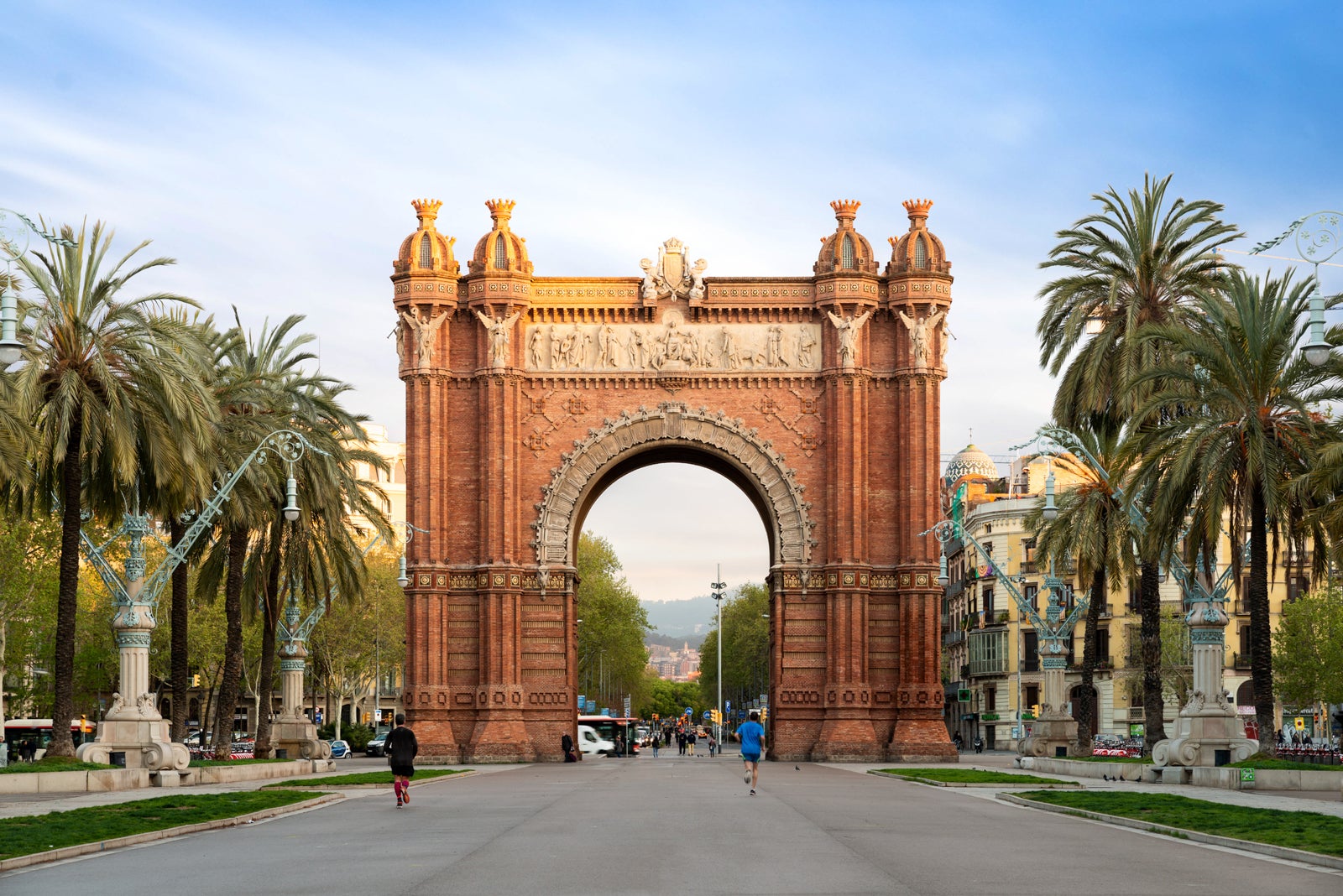 Bacelona Arc de Triomf during sunrise in the city of Barcelona in Catalonia, Spain. The arch is built in reddish brickwork in the Neo-Mudejar style