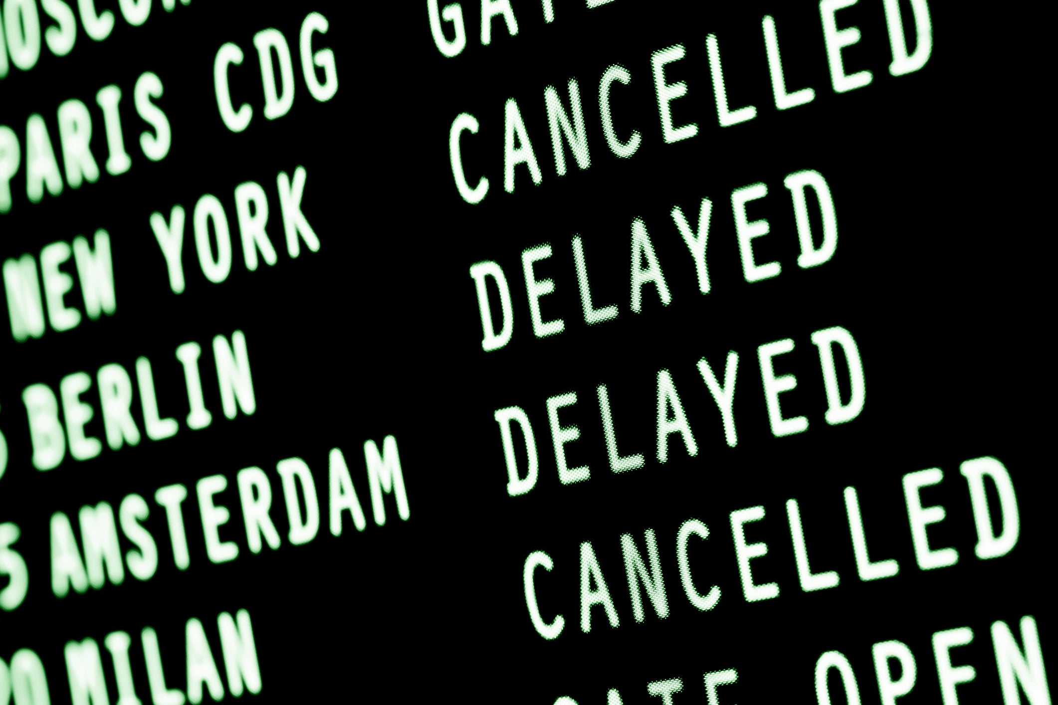 A sign shows names of cities with 'delayed' or 'cancelled' next to all of them