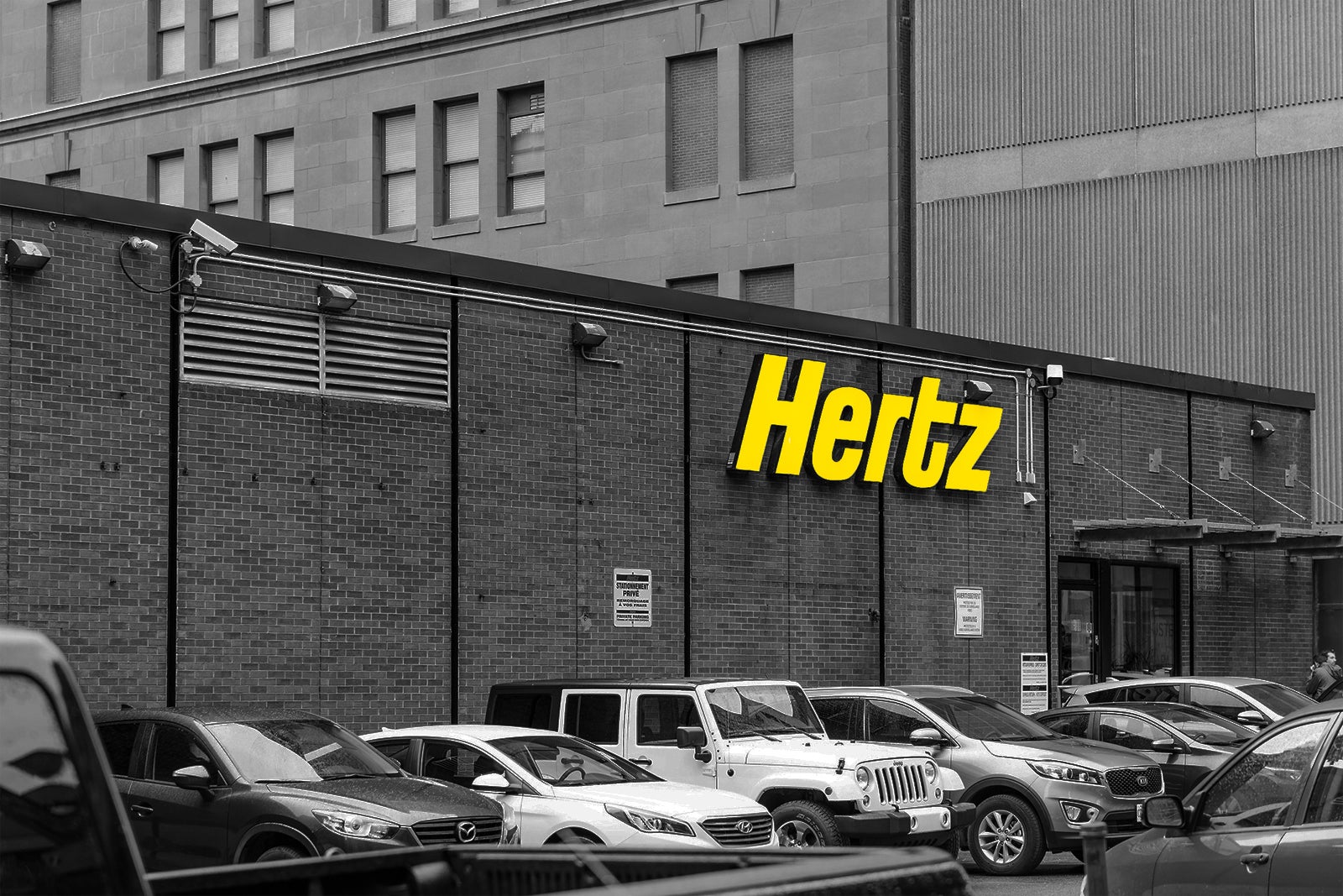 Hertz storefront with cars parked outside