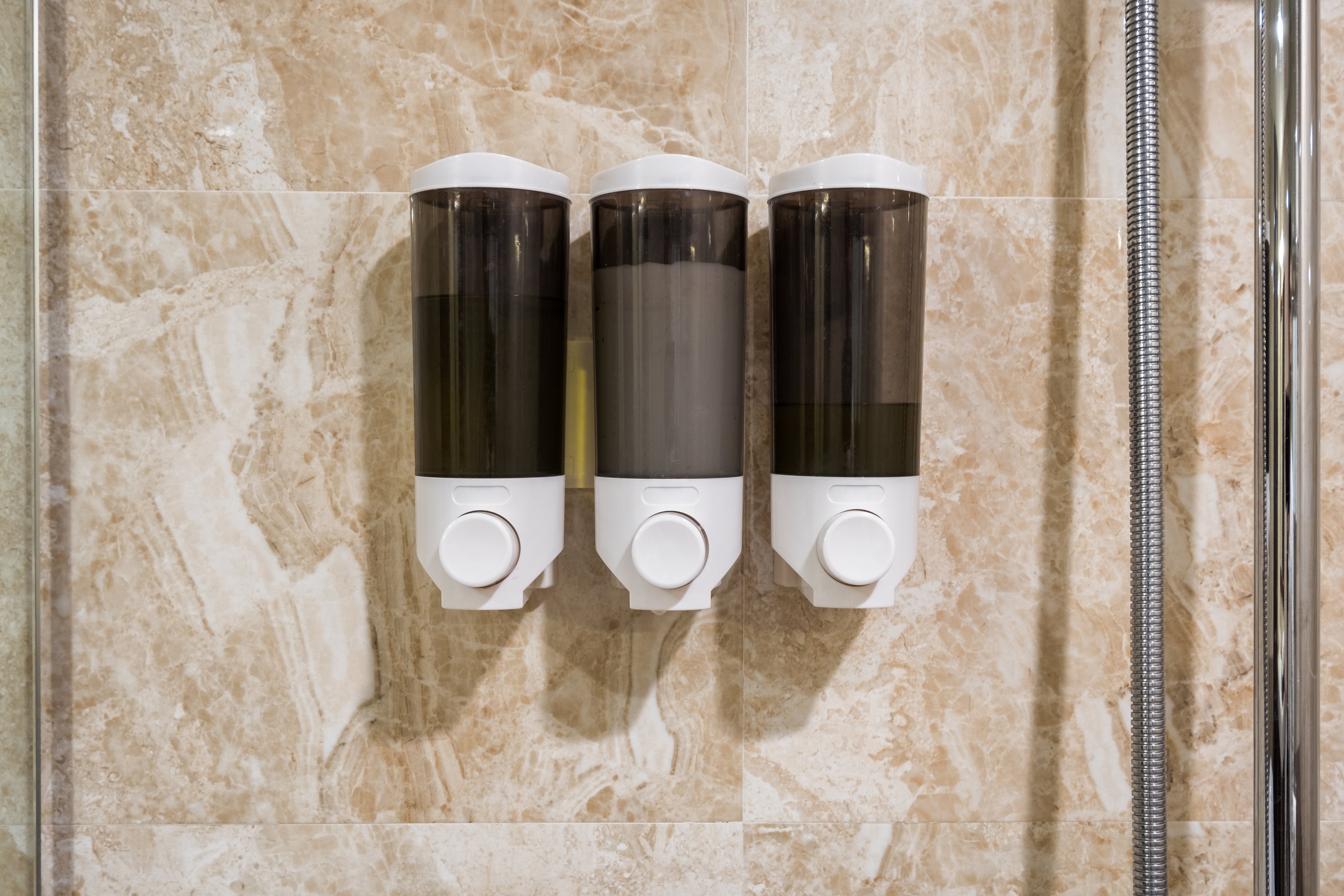 Box of Soap, shampoo, conditioner hang on wall in bathroom