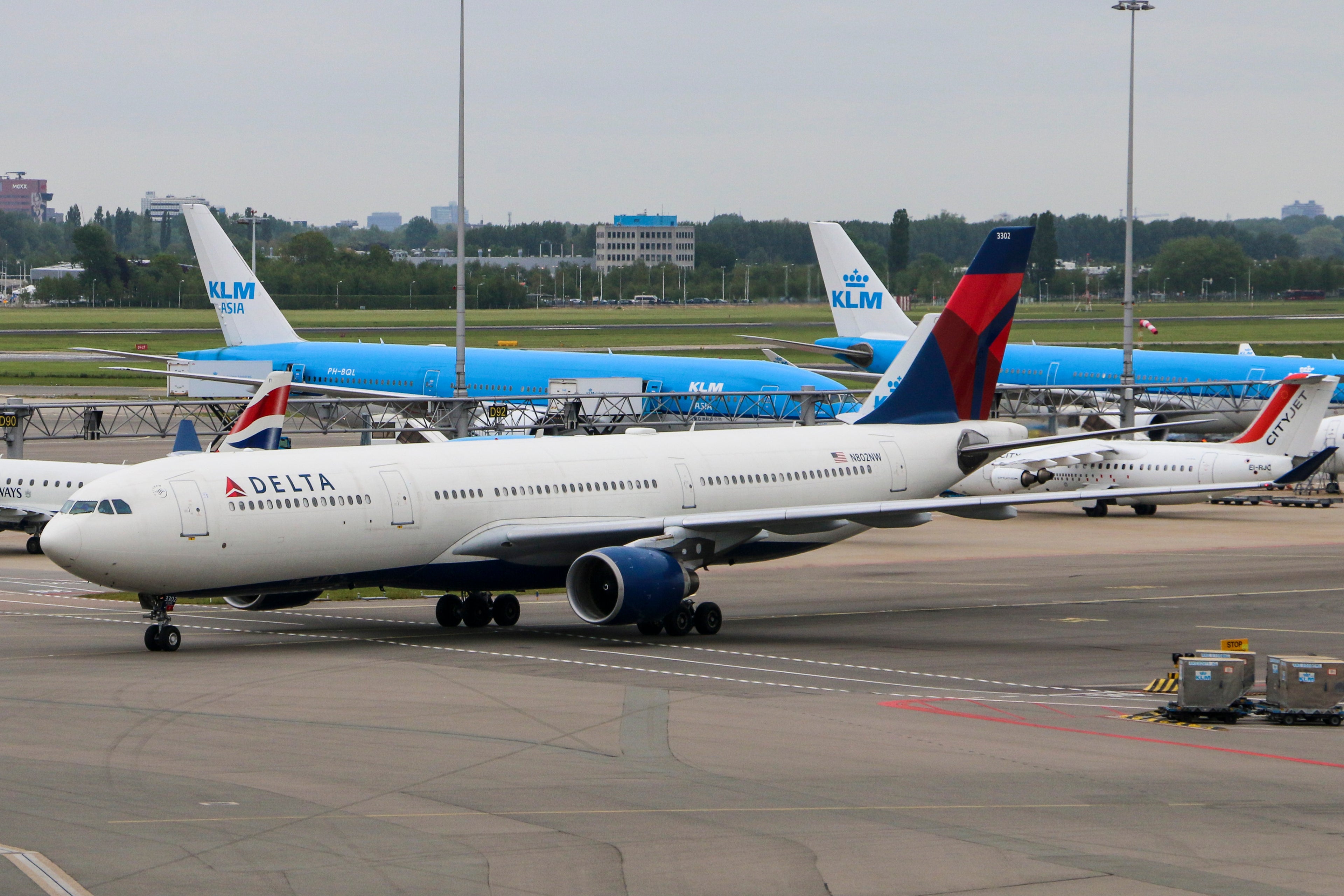 Multiple planes from SkyTeam partners are seen near the runway at Amsterdam's Schiphol airport