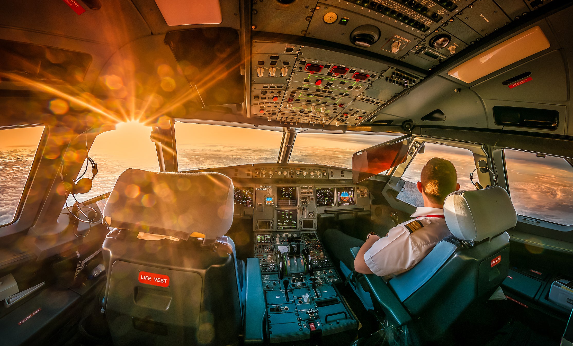 Airline pilot in cockpit watching landscapes, Dubai, United Arab Emirates